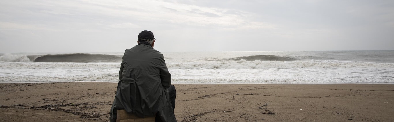 Man sitting alone on a beach